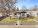 Charming single-story home featuring a well-manicured front yard with mature trees at 4389 S Sherman St, Englewood, CO 80113