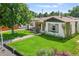 Inviting exterior view showcasing the home's lush lawn, quaint facade, and pleasant landscaping at 4389 S Sherman St, Englewood, CO 80113
