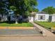 A charming home with a verdant front yard and stone walkway to the front door at 4389 S Sherman St, Englewood, CO 80113