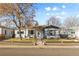 Charming single-story home with a welcoming front porch and well-maintained landscaping at 4389 S Sherman St, Englewood, CO 80113