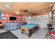 Entertaining game room complete with a pool table, TV, comfortable seating, and vintage decor at 4389 S Sherman St, Englewood, CO 80113