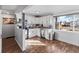Bright kitchen with white cabinetry, stainless steel appliances, and hardwood flooring at 4389 S Sherman St, Englewood, CO 80113
