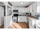 Bright kitchen with white cabinetry, stainless steel appliances, and beautiful countertops at 4389 S Sherman St, Englewood, CO 80113