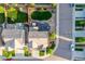 An aerial view shows a home with a well-manicured lawn, patio, and lush landscaping at 14384 Big Stone Dr, Parker, CO 80134