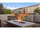 Backyard featuring a fire pit, seating, hot tub, and fenced yard with low-voltage lighting at 14384 Big Stone Dr, Parker, CO 80134