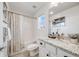 Bathroom features a shower-tub combination, white tile, a window, and a granite countertop on the vanity at 14384 Big Stone Dr, Parker, CO 80134