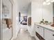 Hallway view of modern bathroom showcasing a glass shower, white vanity with granite countertop, and the bedroom at 14384 Big Stone Dr, Parker, CO 80134