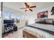 Bedroom features large windows, a ceiling fan, a desk, and a comfortable bed with stylish bedding at 14384 Big Stone Dr, Parker, CO 80134