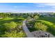 Scenic community park with a paved path, mature trees, and well-maintained green spaces at 14384 Big Stone Dr, Parker, CO 80134