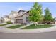 Charming two-story home with a two-car garage, stone accents, and a well-manicured front yard with mature trees at 14384 Big Stone Dr, Parker, CO 80134
