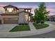 Beautiful two-story home featuring a two-car garage, stone accents and manicured lawn with mature trees at 14384 Big Stone Dr, Parker, CO 80134