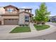 Charming two-story home with a well-manicured lawn, stone accents, and an attached two-car garage at 14384 Big Stone Dr, Parker, CO 80134