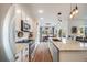 Modern kitchen features stainless steel appliances, white cabinets, granite countertops, and pendant lighting at 14384 Big Stone Dr, Parker, CO 80134