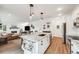 Open-concept kitchen with island, pendant lighting, and stainless steel appliances at 14384 Big Stone Dr, Parker, CO 80134
