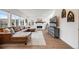 Bright living room with hardwood floors, a fireplace, large windows, and comfortable leather sectional sofa at 14384 Big Stone Dr, Parker, CO 80134