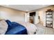 Well-lit primary bedroom featuring a large bed, plush bedding, and views of the bathroom at 14384 Big Stone Dr, Parker, CO 80134
