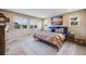 Comfortable bedroom with large windows, neutral paint, and a stylish area rug at 14384 Big Stone Dr, Parker, CO 80134