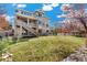 This backyard features a large grassy area and a charming deck, perfect for outdoor living at 5289 W Euclid Pl, Littleton, CO 80123
