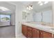 The bathroom features double sinks with a vanity, a mirror, and vanity lighting at 5289 W Euclid Pl, Littleton, CO 80123