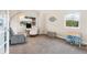 Bright bedroom with neutral walls, gray carpet, a dollhouse, and ample natural light from the window at 5289 W Euclid Pl, Littleton, CO 80123
