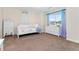 This well-lit bedroom features a cozy bed, dresser, and a large window at 5289 W Euclid Pl, Littleton, CO 80123