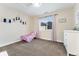 This charming bedroom includes a cozy bed, a window, and a dresser for ample storage at 5289 W Euclid Pl, Littleton, CO 80123
