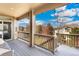 Exterior view of the deck, with seating and a view of the backyard and neighborhood at 5289 W Euclid Pl, Littleton, CO 80123