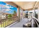 Inviting covered deck with comfortable seating and views of the surrounding landscape at 5289 W Euclid Pl, Littleton, CO 80123