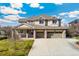 Stunning two-story home featuring a three-car garage and inviting front porch with brick and siding exterior at 5289 W Euclid Pl, Littleton, CO 80123