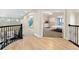 Hallway with hardwood floors leading to a bedroom with ensuite bathroom at 5289 W Euclid Pl, Littleton, CO 80123
