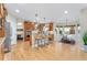 Bright, open kitchen with stainless steel appliances, center island, and dining area at 5289 W Euclid Pl, Littleton, CO 80123