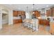 Large kitchen featuring granite countertops, a center island with bar stools, and stainless steel appliances at 5289 W Euclid Pl, Littleton, CO 80123