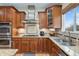 Close up of kitchen features with stainless steel range, granite countertop and wood cabinets at 5289 W Euclid Pl, Littleton, CO 80123