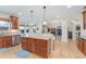 Gourmet kitchen with hardwood floors, center island, stainless steel appliances, and open layout to the living area at 5289 W Euclid Pl, Littleton, CO 80123