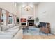 Elegant living room with a soaring ceiling, fireplace, and ample natural light at 5289 W Euclid Pl, Littleton, CO 80123