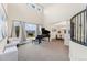 Spacious living room featuring a grand piano, large windows, and access to the formal dining area at 5289 W Euclid Pl, Littleton, CO 80123