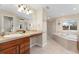 Luxurious main bathroom with dual sinks, soaking tub, and separate shower at 5289 W Euclid Pl, Littleton, CO 80123