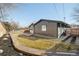 Backyard with lawn, patio, privacy fence, and home exterior with contemporary style at 621 S Harrison Ln, Denver, CO 80209