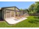 Well-manicured backyard with lush green lawn, a patio, and stylish outdoor furniture at 621 S Harrison Ln, Denver, CO 80209