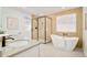 Modern bathroom featuring a double sink vanity, soaking tub, and walk-in shower at 621 S Harrison Ln, Denver, CO 80209
