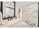 Modern bathroom featuring marble tiled shower, sleek black fixtures and decorative mirror for a spa-like feel at 621 S Harrison Ln, Denver, CO 80209