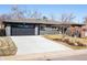 Well-maintained one-story home with a two-car garage and a concrete driveway and mature landscaping at 621 S Harrison Ln, Denver, CO 80209