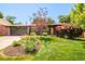 Charming single-story home featuring a landscaped front yard and an attached two-car garage at 621 S Harrison Ln, Denver, CO 80209