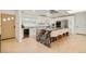 Modern kitchen features stainless appliances, white cabinets and a marble island with barstool seating at 621 S Harrison Ln, Denver, CO 80209