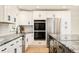 Updated kitchen featuring stainless steel appliances, double oven, and modern white cabinetry at 621 S Harrison Ln, Denver, CO 80209