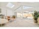 Inviting living room with vaulted ceilings, skylight and sliding glass doors to backyard patio at 621 S Harrison Ln, Denver, CO 80209