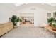 Open-concept sunroom with brick accent wall and stylish furnishings at 621 S Harrison Ln, Denver, CO 80209
