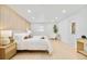 Bright bedroom features stylish wood accent wall, neutral décor, and an ensuite bathroom at 621 S Harrison Ln, Denver, CO 80209
