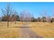 Picturesque park featuring a walking path lined with mature trees, provides a serene and natural environment at 621 S Harrison Ln, Denver, CO 80209