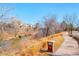 Neighborhood street view with a sidewalk near the river and the community is on the other side at 621 S Harrison Ln, Denver, CO 80209
